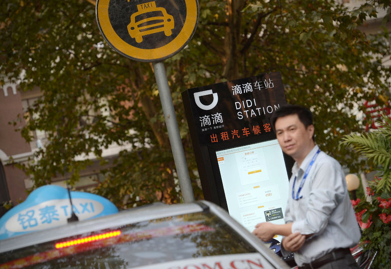 A driver waits for a fare at a Didi Station in Shanghai.